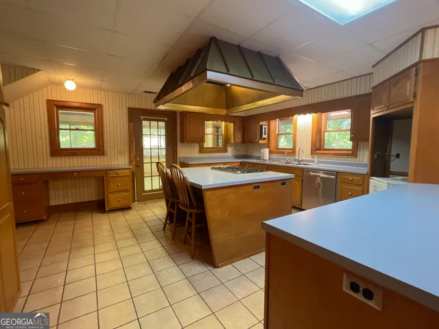 a kitchen with stainless steel appliances granite countertop a sink counter space and cabinets