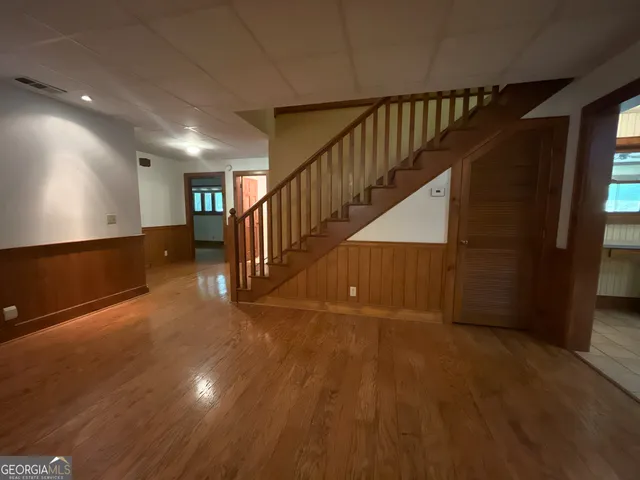a view of an entryway with wooden floor