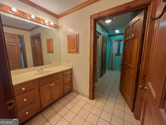 a bathroom with a sink a mirror and a shower