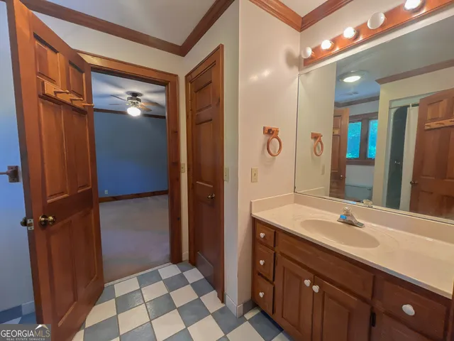 a bathroom with a sink a mirror and a shower