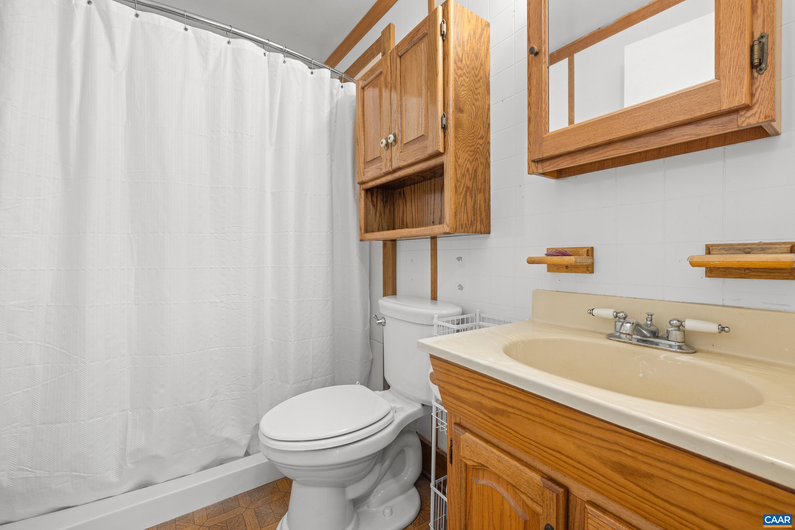 3590 Green Creek Road Schuyler, VA 22969 - Photo 15 of 25 a bathroom with a sink a toilet and shower curtain