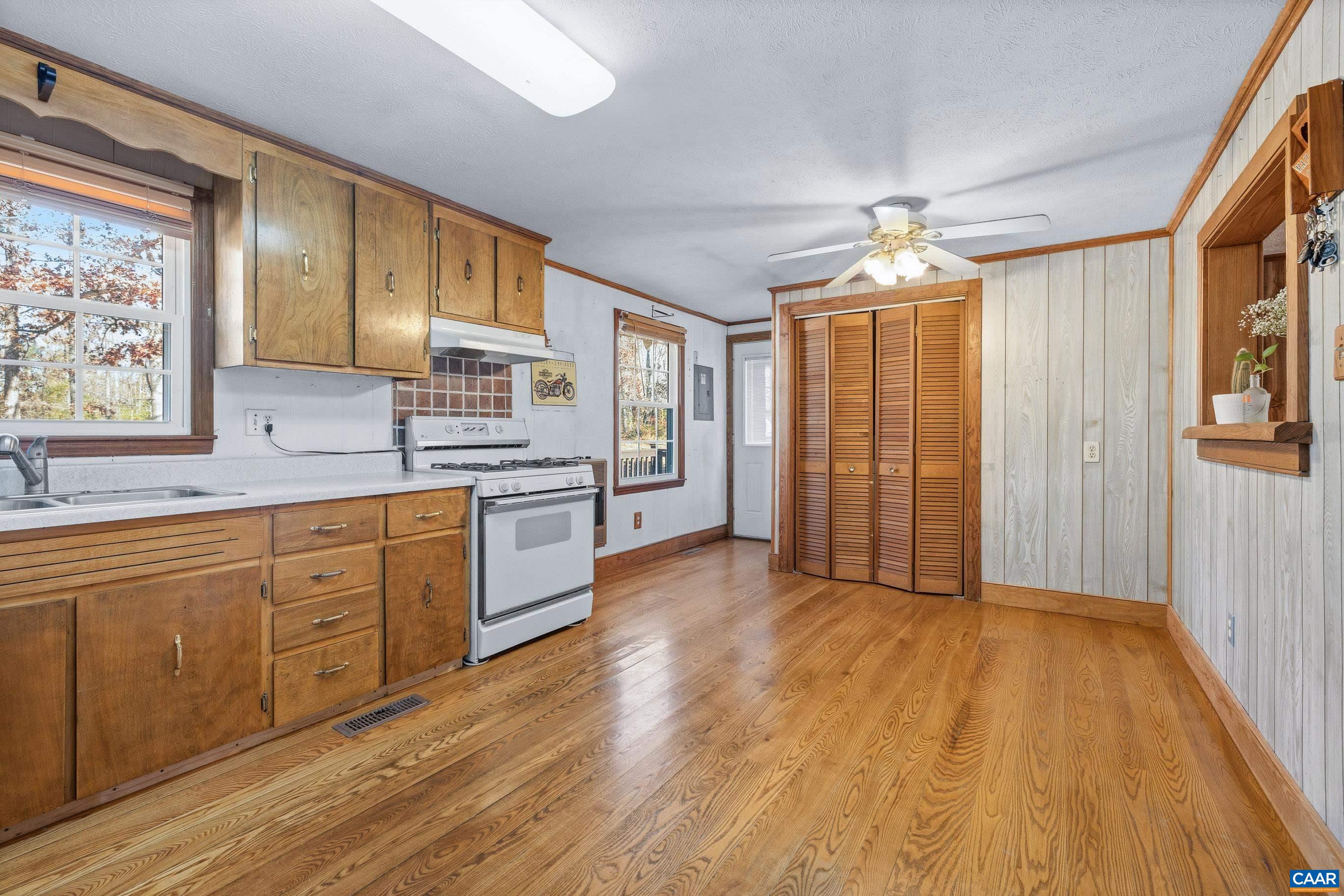 3590 Green Creek Road Schuyler, VA 22969 - Photo 4 of 25 a kitchen with stainless steel appliances granite countertop a stove a sink dishwasher and a refrigerator with wooden floor