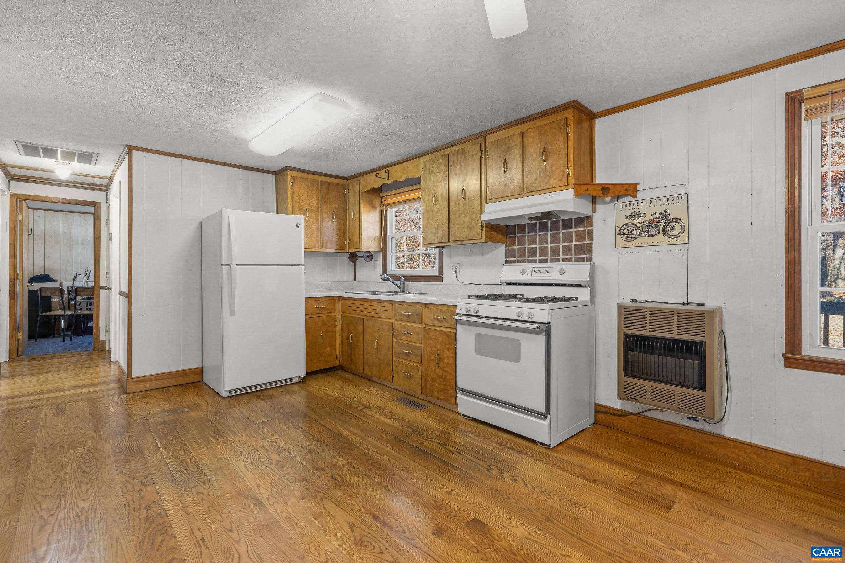 3590 Green Creek Road Schuyler, VA 22969 - Photo 5 of 25 a kitchen with a white cabinets and white appliances