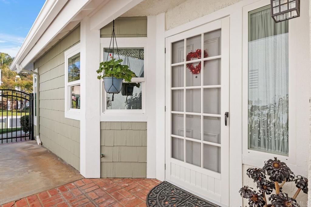 6833 Watercourse Drive Carlsbad, CA 92011 - Photo 16 of 49 a view of front door and a potted plant