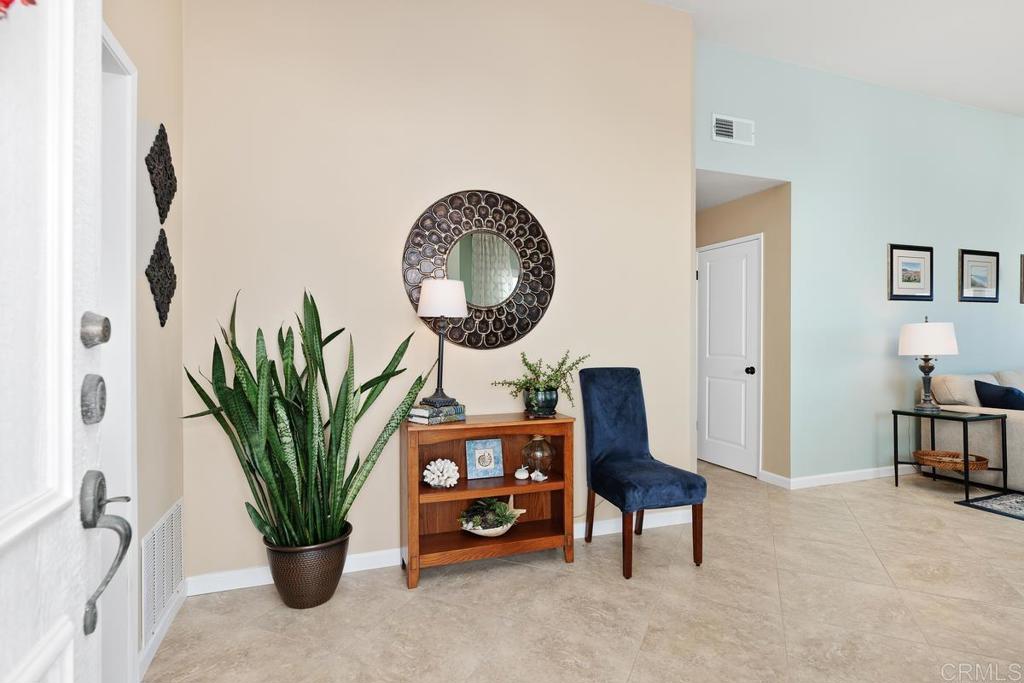 6833 Watercourse Drive Carlsbad, CA 92011 - Photo 17 of 49 a living room with furniture potted plant and a window