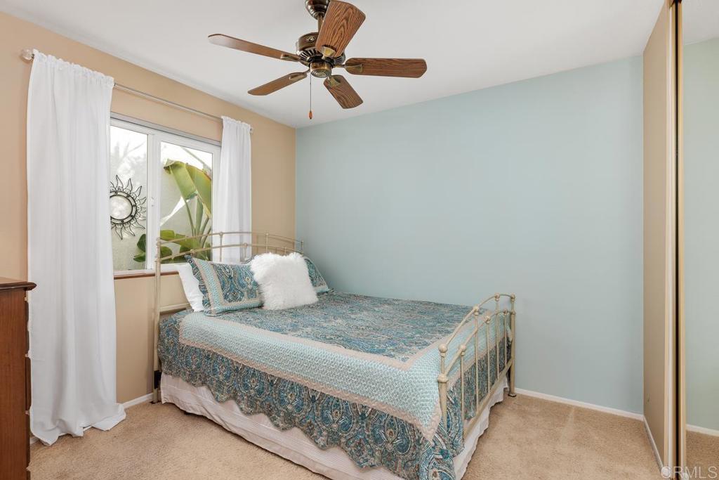 6833 Watercourse Drive Carlsbad, CA 92011 - Photo 19 of 49 a bedroom with a bed and a chandelier