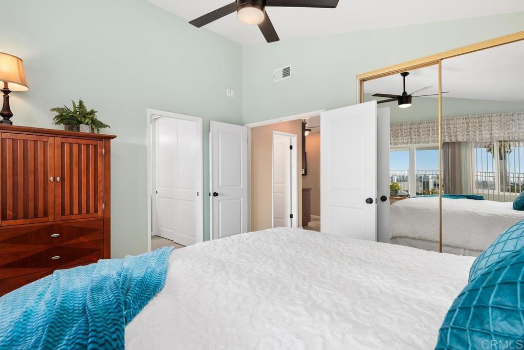 6833 Watercourse Drive Carlsbad, CA 92011 - Photo 30 of 49 a bedroom with a bed and a mirror