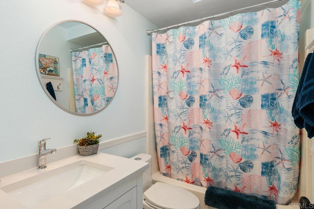 6833 Watercourse Drive Carlsbad, CA 92011 - Photo 34 of 49 a bathroom with a toilet sink and mirror