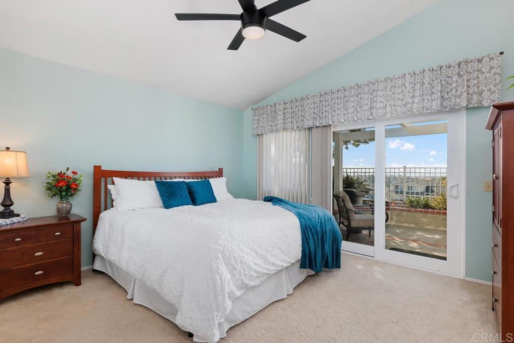 6833 Watercourse Drive Carlsbad, CA 92011 - Photo 4 of 49 a spacious bedroom with a bed and a chandelier