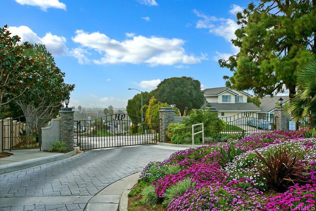 6833 Watercourse Drive Carlsbad, CA 92011 - Photo 43 of 49 a view of a house with a big yard and flower plants