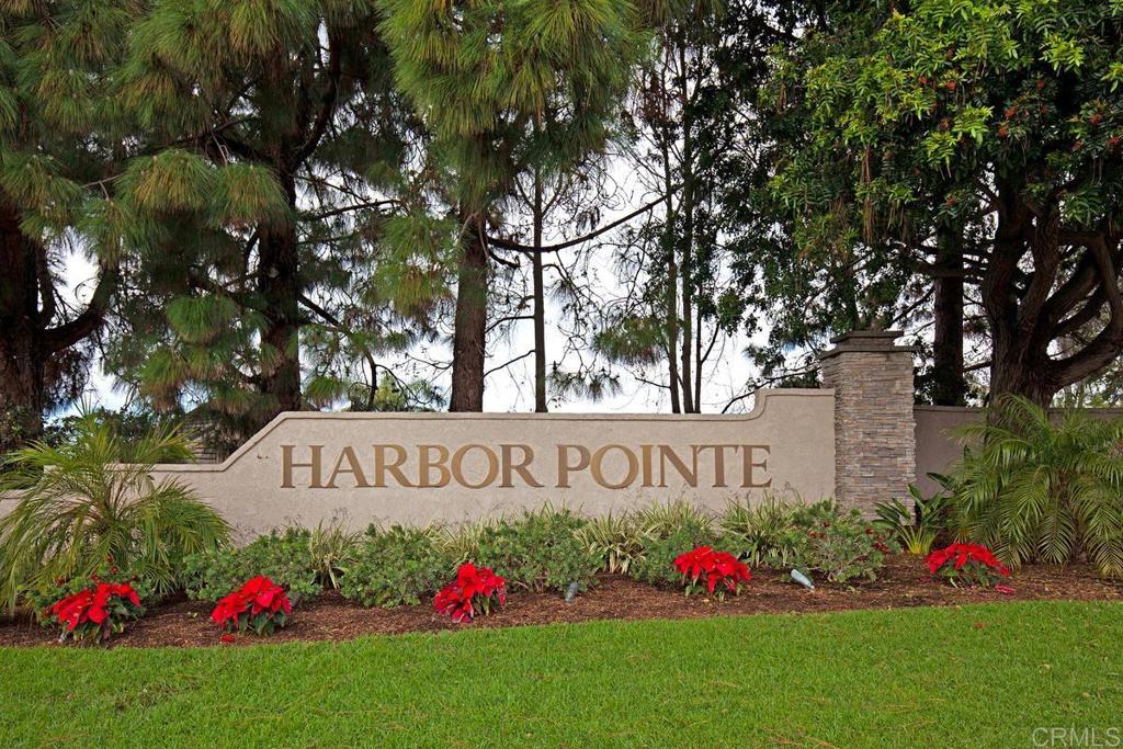 6833 Watercourse Drive Carlsbad, CA 92011 - Photo 47 of 49 a sign of golf club on a wall under a tree