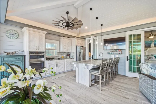 a living room with furniture and view of kitchen