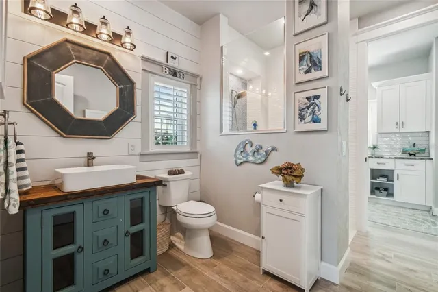 a bathroom with a toilet sink and mirror