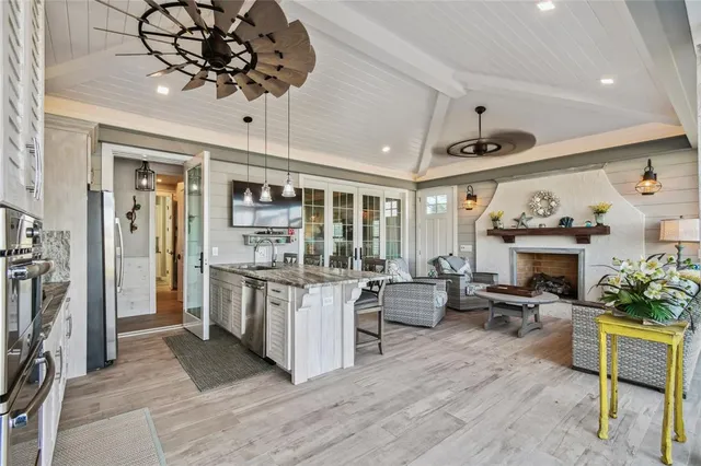 a living room with furniture a fireplace and a chandelier