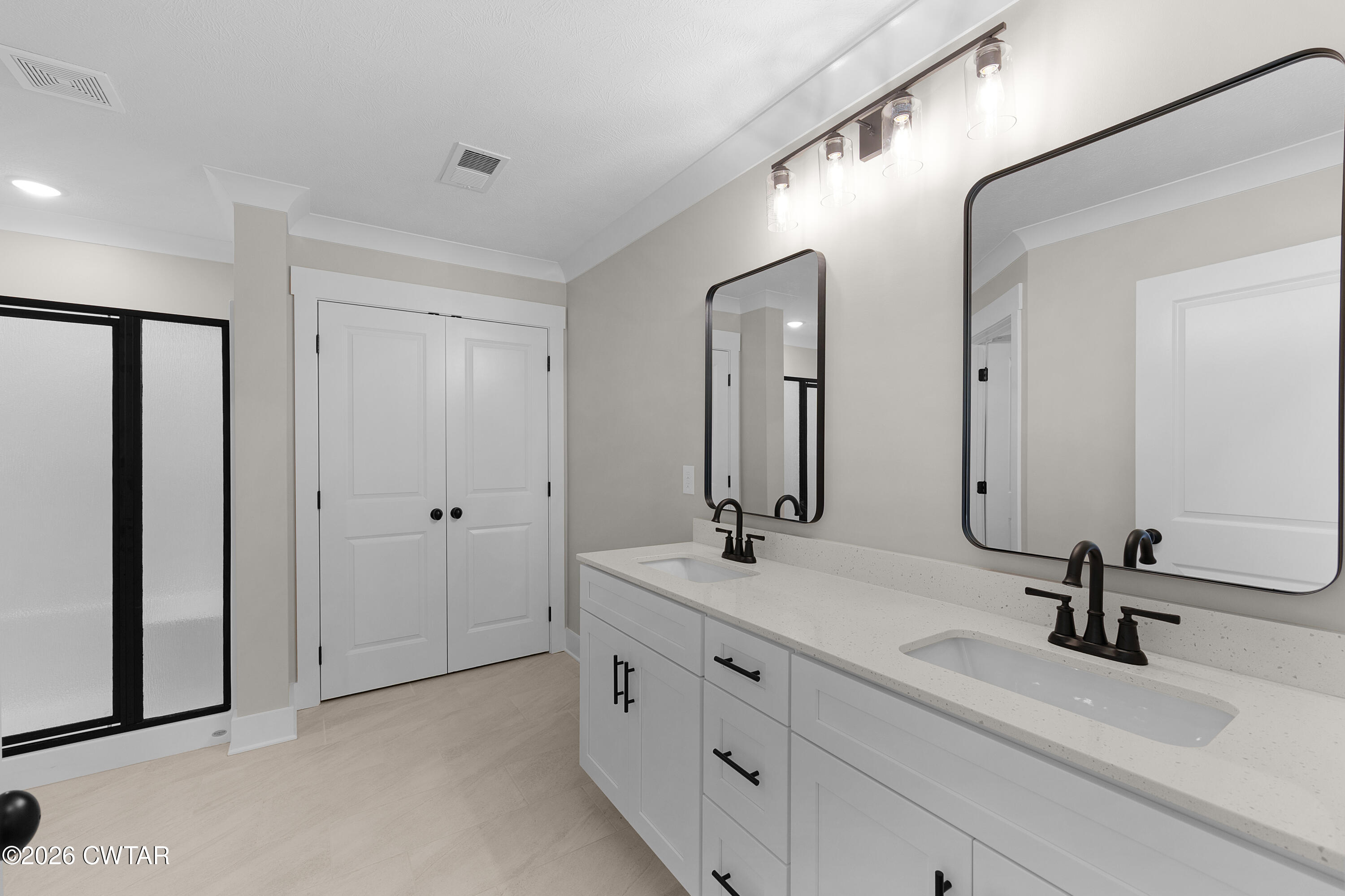 19 Emerald Downs Three Way, TN 38343 - Photo 11 of 17 a bathroom with a double vanity sink and mirror