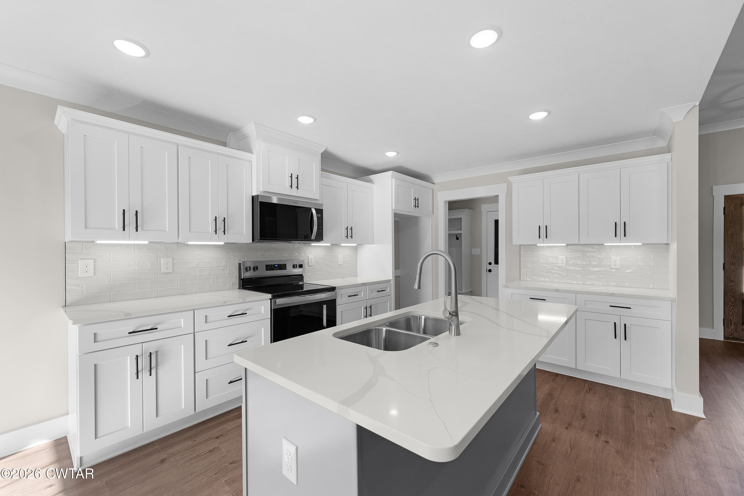 19 Emerald Downs Three Way, TN 38343 - Photo 5 of 17 a kitchen with white cabinets and stainless steel appliances