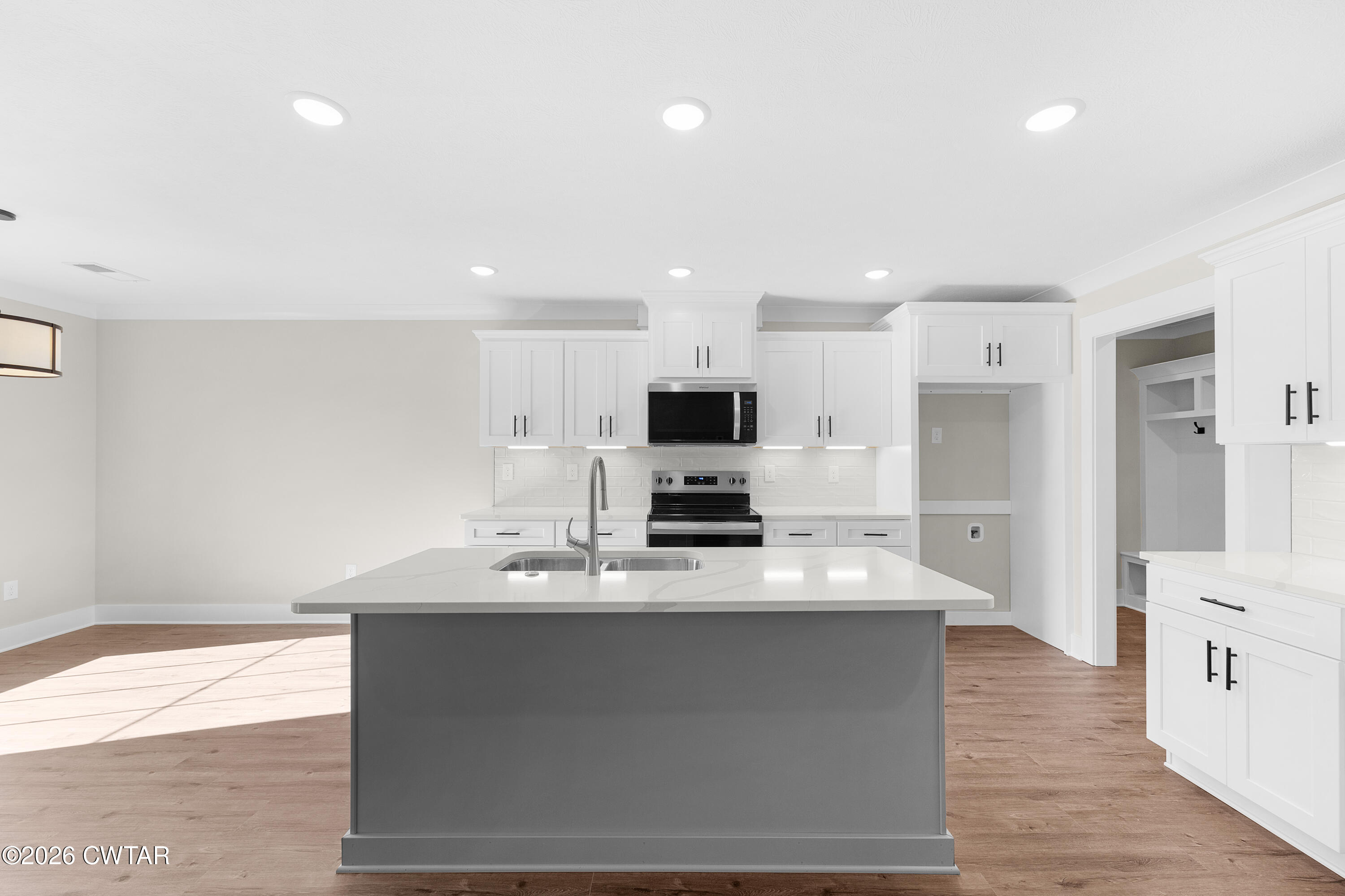 19 Emerald Downs Three Way, TN 38343 - Photo 6 of 17 a large white kitchen with wooden floor