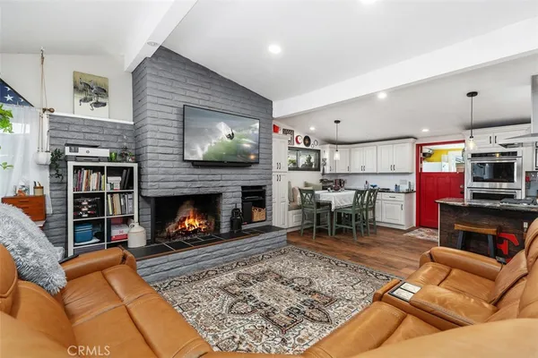 a living room with furniture and kitchen view