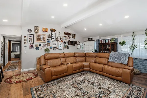 a kitchen with stainless steel appliances kitchen island granite countertop a table chairs and a refrigerator