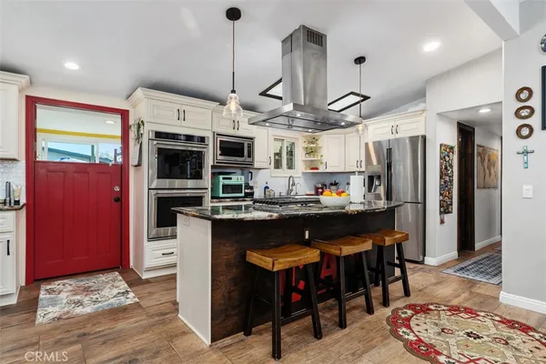 a kitchen with stainless steel appliances granite countertop a stove and refrigerator