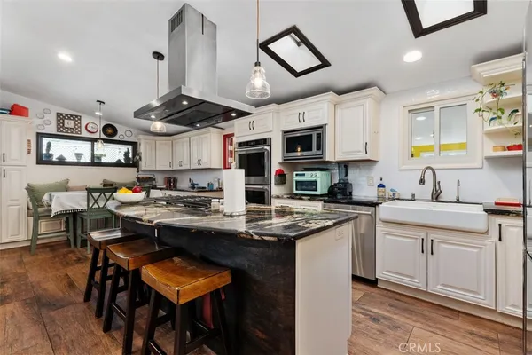 a kitchen with stainless steel appliances granite countertop a stove and a sink