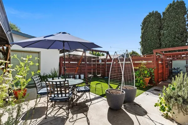 a view of a house with backyard sitting area and slide