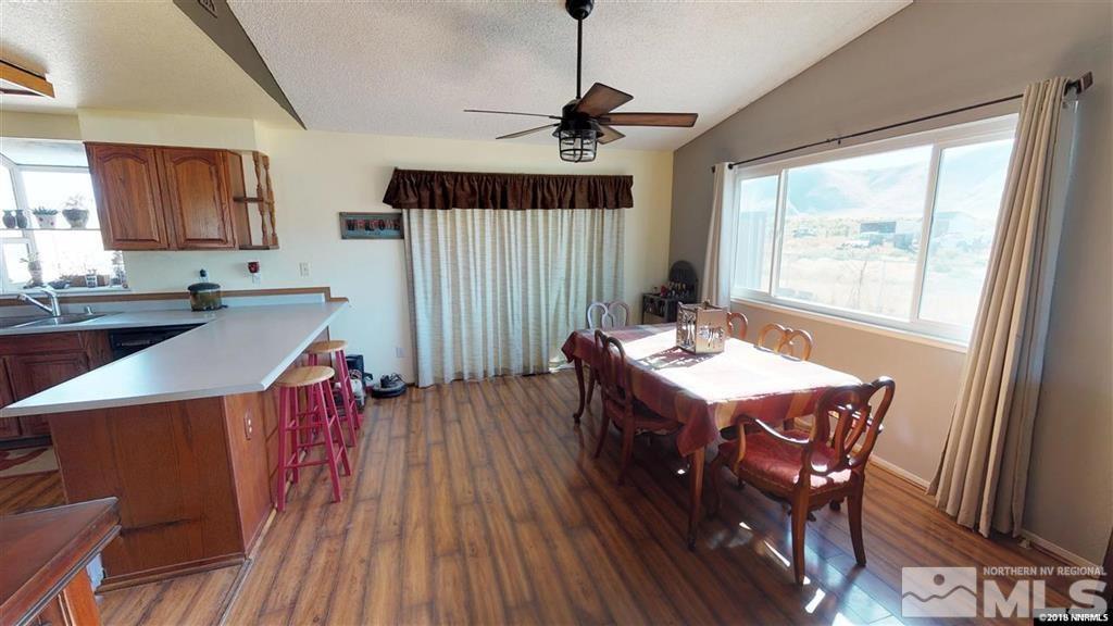 8300 Osage Road Reno, NV 89508 - Photo 4 of 22 a living room with a table chairs and a wooden floor