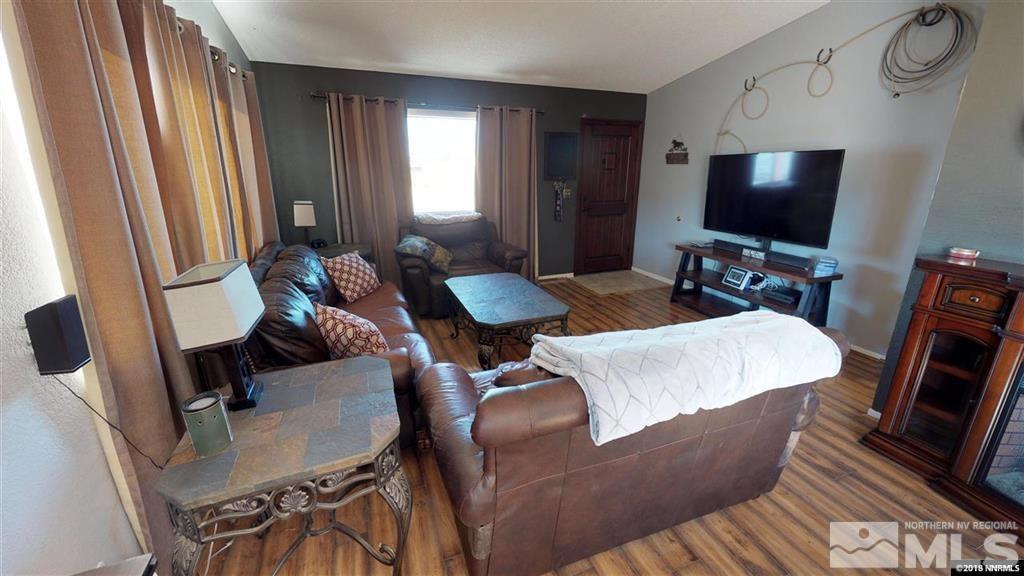 8300 Osage Road Reno, NV 89508 - Photo 8 of 22 a living room with furniture and a flat screen tv
