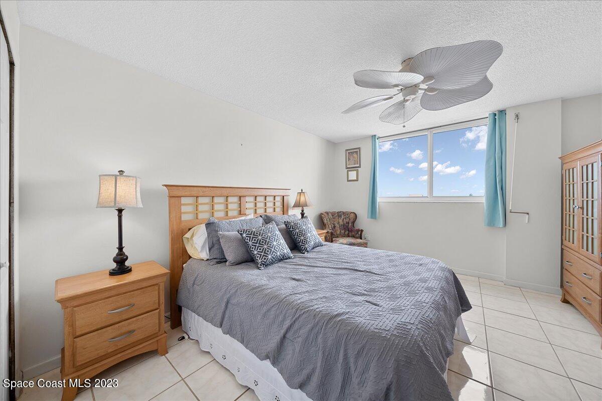 2020 North Atlantic Avenue, Unit 505 Cocoa Beach, FL 32931 - Photo 12 of 16 a bedroom with a bed and a lamp