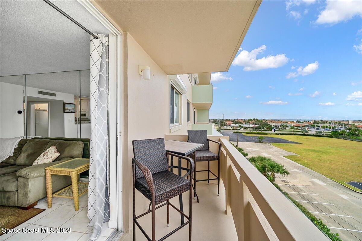 2020 North Atlantic Avenue, Unit 505 Cocoa Beach, FL 32931 - Photo 16 of 16 a view of a balcony with furniture and carpet