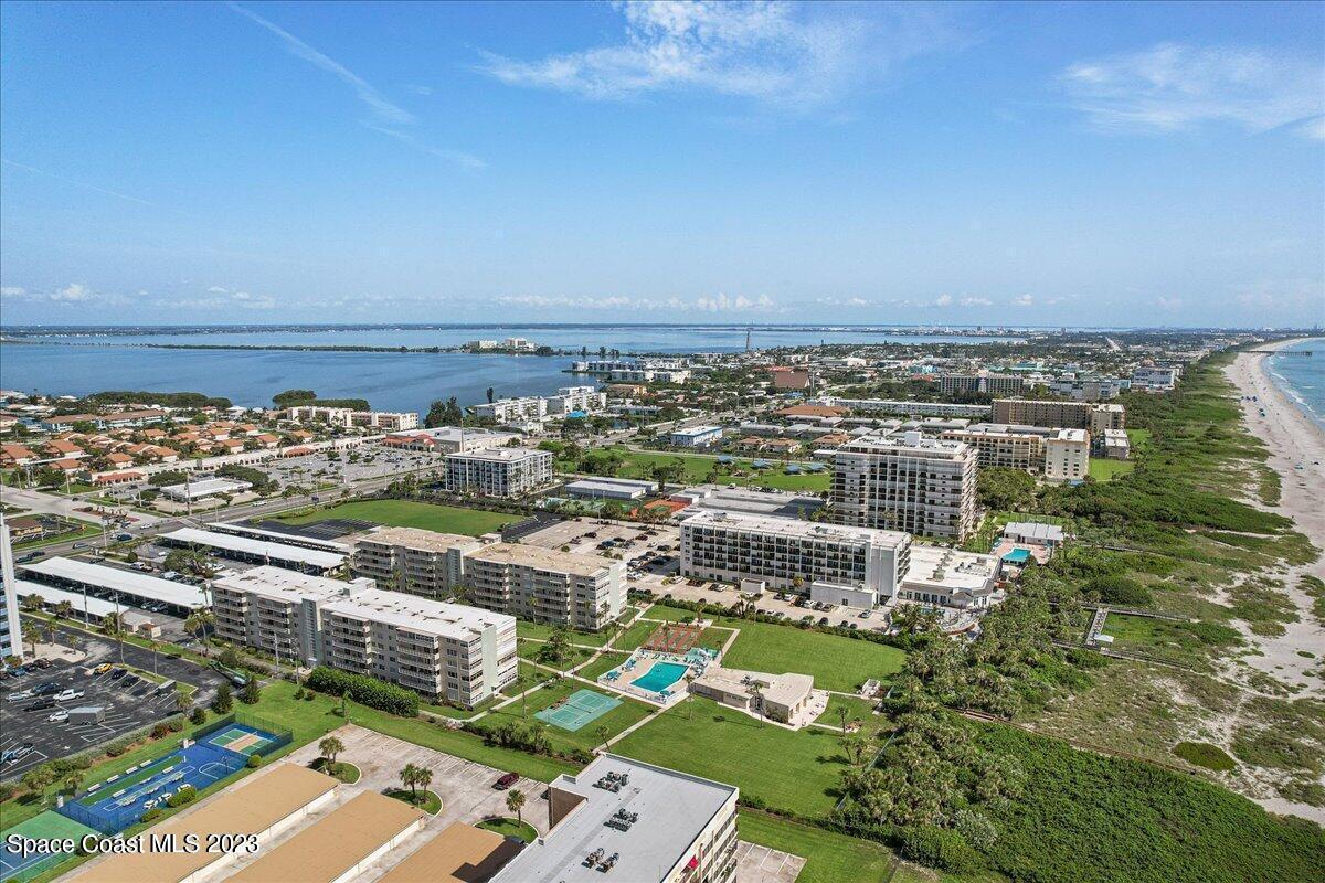 2020 North Atlantic Avenue, Unit 505 Cocoa Beach, FL 32931 - Photo 4 of 16 an aerial view of a city with lots of residential buildings ocean and mountain view in back