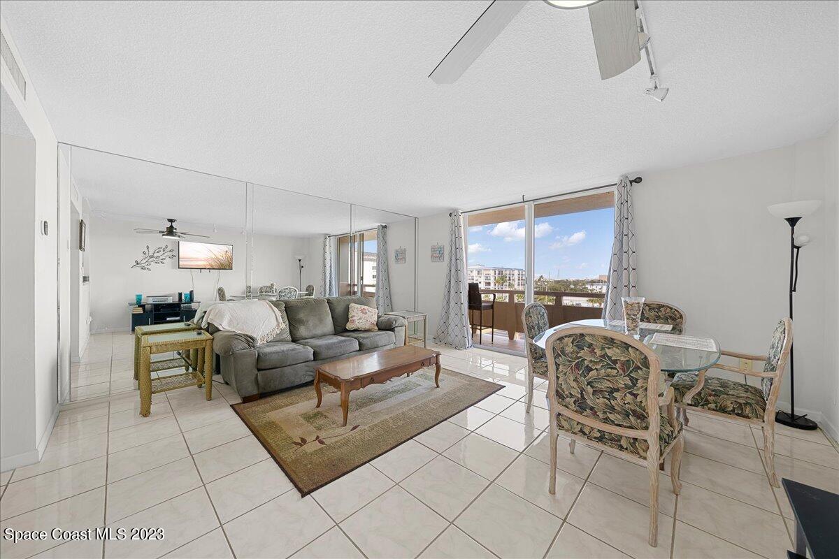 2020 North Atlantic Avenue, Unit 505 Cocoa Beach, FL 32931 - Photo 8 of 16 a living room with furniture and a large window