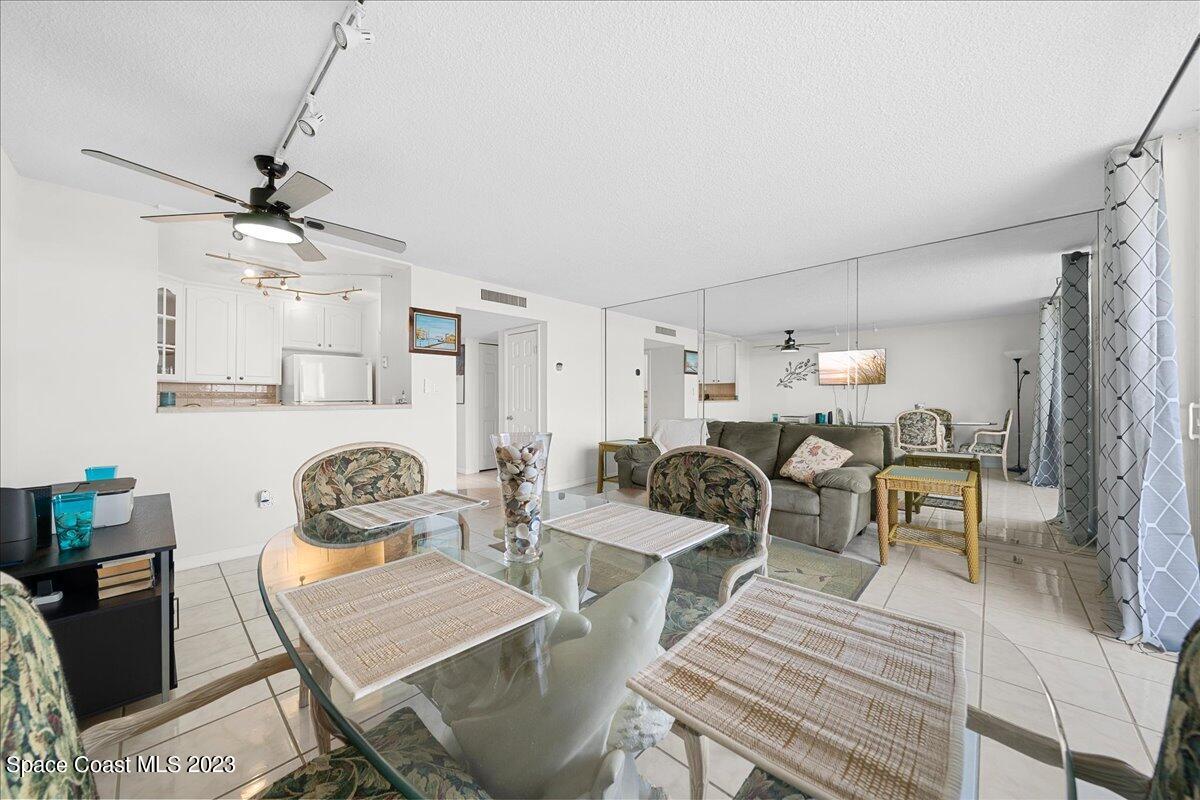 2020 North Atlantic Avenue, Unit 505 Cocoa Beach, FL 32931 - Photo 9 of 16 a living room with furniture and a chandelier