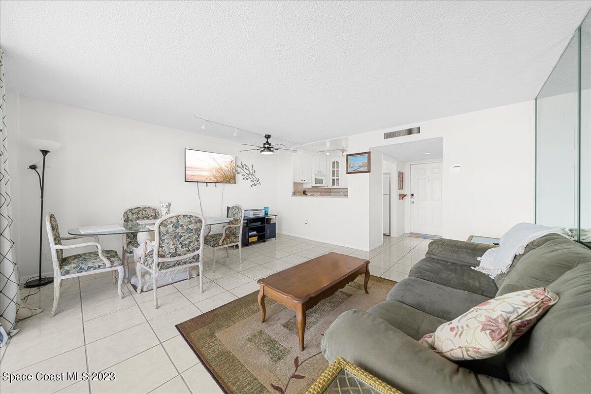 2020 North Atlantic Avenue, Unit 505 Cocoa Beach, FL 32931 - Photo 10 of 16 a living room with furniture and a table