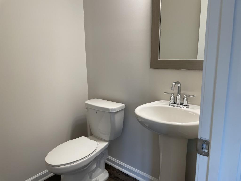 3400 Reagan Way Lawrenceville, GA 30044 - Photo 13 of 20 a white toilet sitting next to a bathroom sink