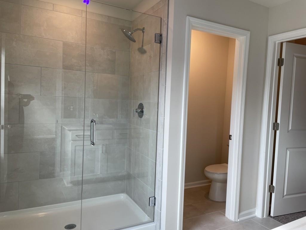 3400 Reagan Way Lawrenceville, GA 30044 - Photo 14 of 20 a bathroom with a shower and a toilet