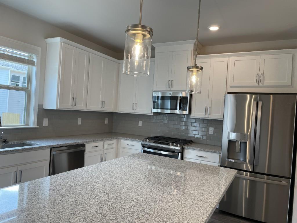 3400 Reagan Way Lawrenceville, GA 30044 - Photo 8 of 20 a kitchen with stainless steel appliances granite countertop a refrigerator a stove and a sink