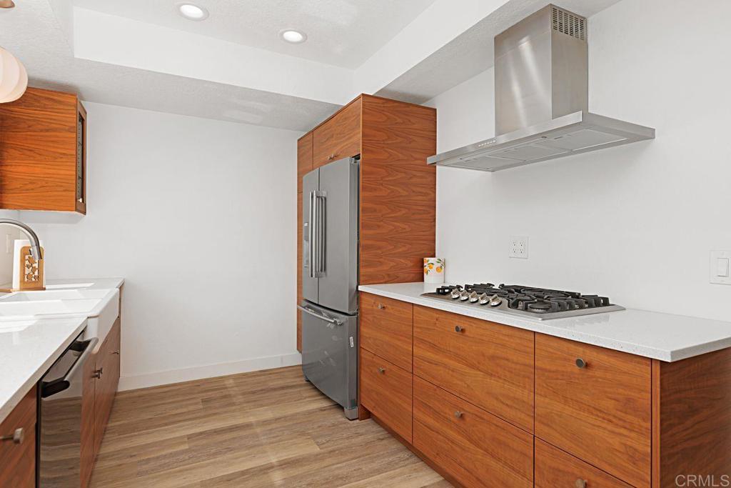 1917 Comanche Street Oceanside, CA 92056 - Photo 12 of 39 a kitchen with stainless steel appliances granite countertop a stove and a refrigerator