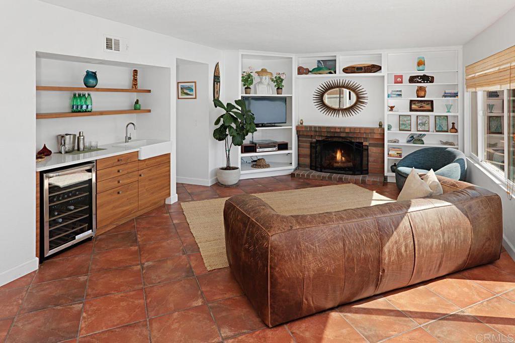 1917 Comanche Street Oceanside, CA 92056 - Photo 14 of 39 a spacious bedroom with a bed and a fireplace