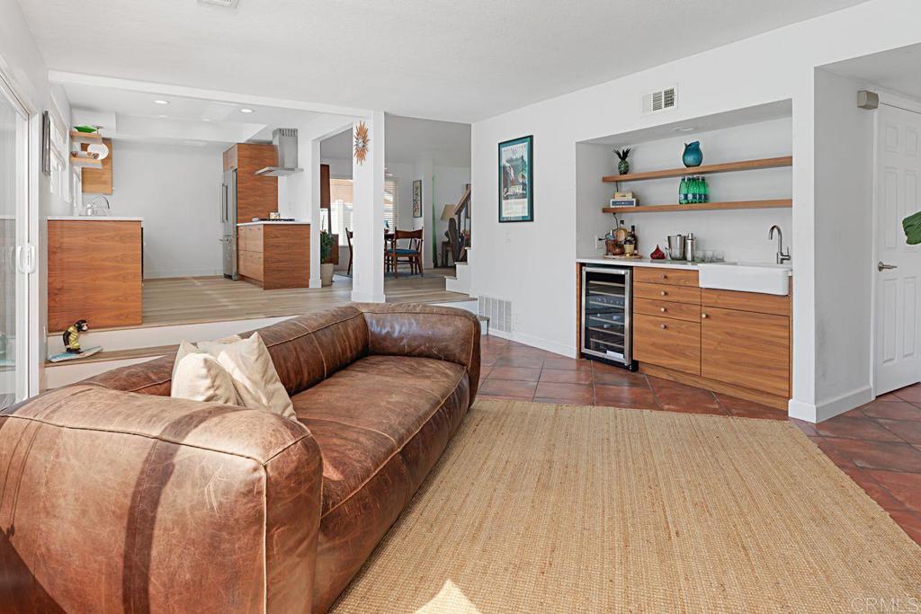 1917 Comanche Street Oceanside, CA 92056 - Photo 16 of 39 a living room with furniture and a wooden floor