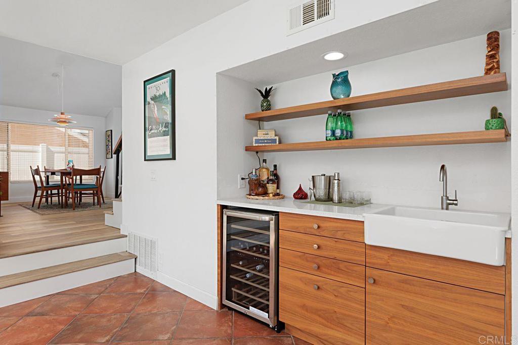 1917 Comanche Street Oceanside, CA 92056 - Photo 17 of 39 a kitchen with a wooden floor and cabinets