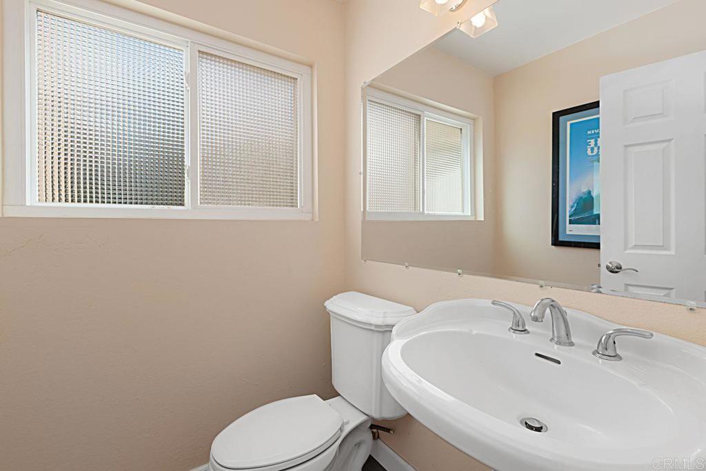 1917 Comanche Street Oceanside, CA 92056 - Photo 18 of 39 a bathroom with a sink mirror and toilet