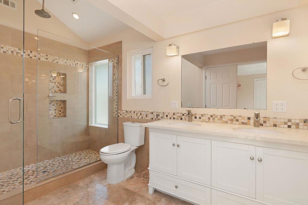 1917 Comanche Street Oceanside, CA 92056 - Photo 21 of 39 a bathroom with a double vanity sink toilet mirror and shower