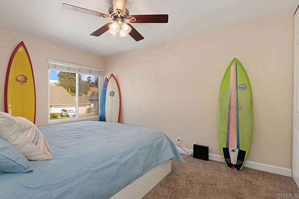 1917 Comanche Street Oceanside, CA 92056 - Photo 25 of 39 a bed room with a bed and a chandelier