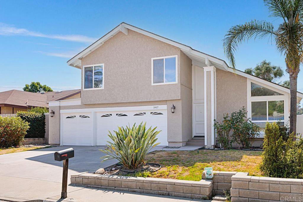 1917 Comanche Street Oceanside, CA 92056 - Photo 3 of 39 a front view of a house with swimming pool and sitting area