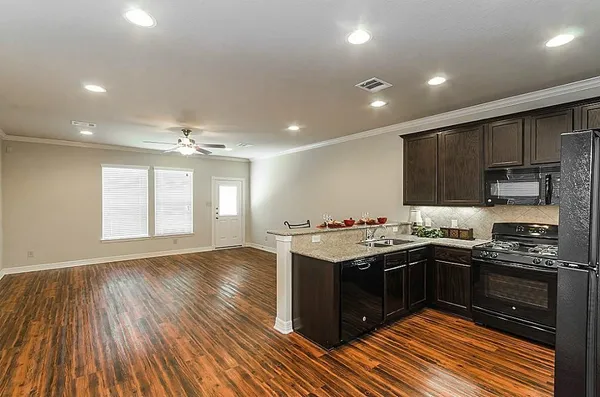 a kitchen with stainless steel appliances granite countertop a stove and a sink