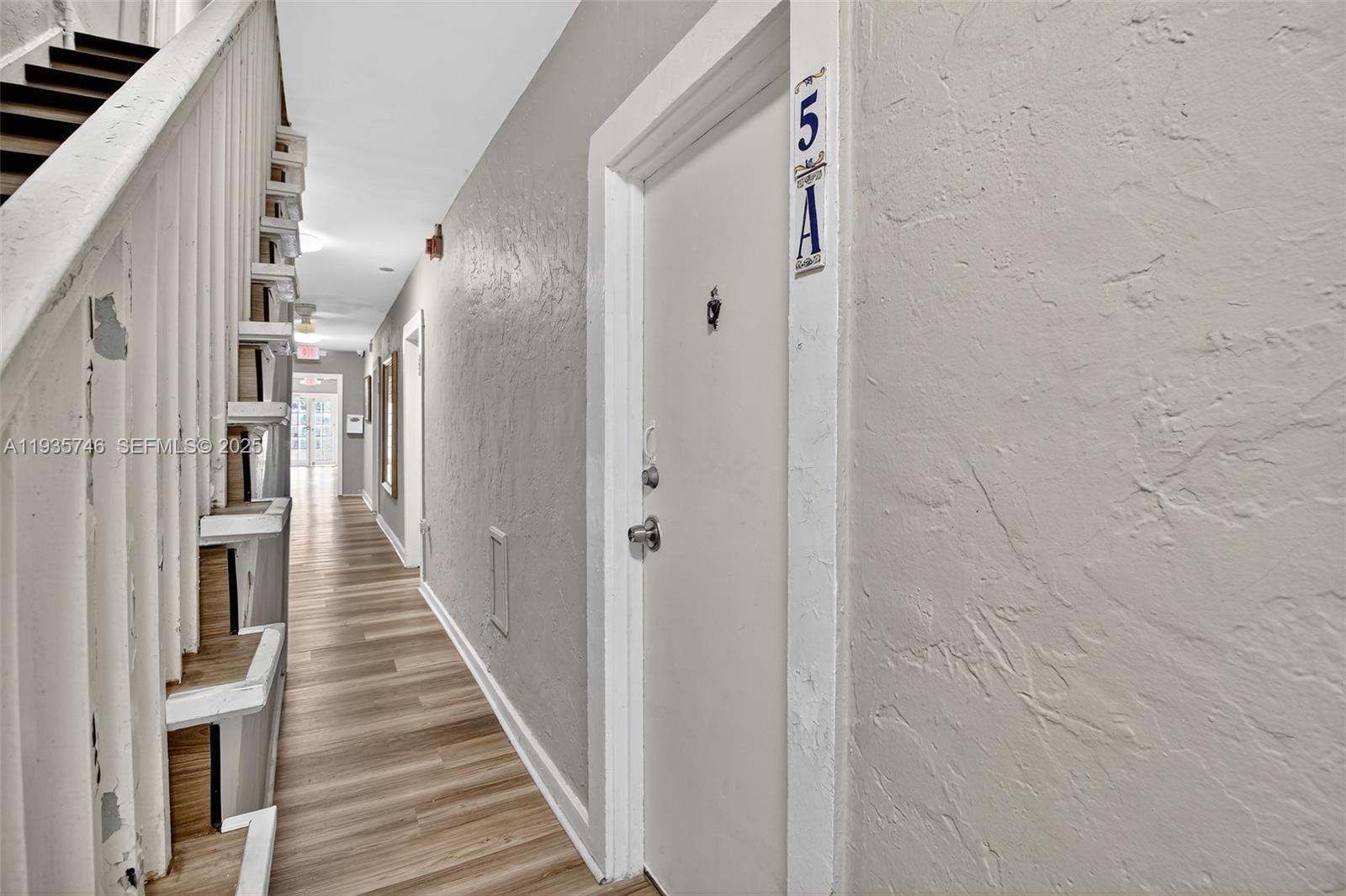 3409 South Le Jeune Road, Unit 5 Coral Gables, FL 33134 - Photo 14 of 14 a view of a hallway with wooden floor and entryway