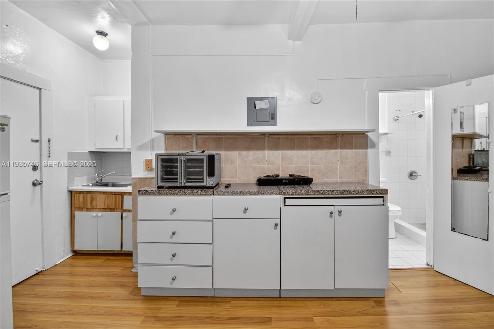 3409 South Le Jeune Road, Unit 5 Coral Gables, FL 33134 - Photo 4 of 14 a kitchen with stainless steel appliances a stove refrigerator sink and cabinets