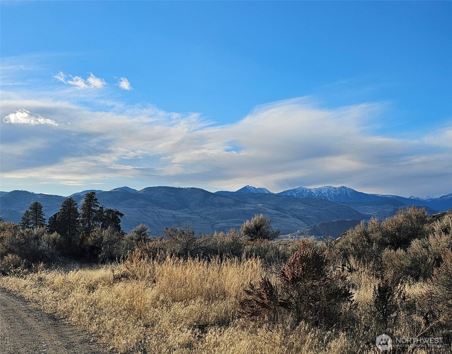 21 Pine Grove Road, Unit LOT 47 Oroville, WA 98844 - Photo 1 of 29 a view of a lake with mountains in the background