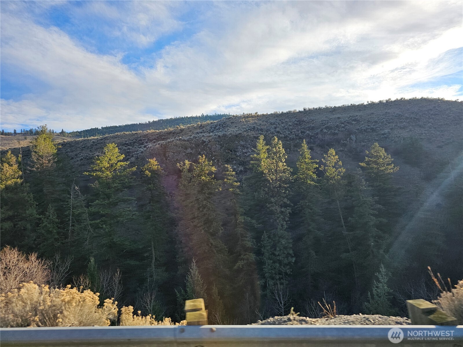 21 Pine Grove Road, Unit LOT 47 Oroville, WA 98844 - Photo 20 of 29 a view of a lake with a mountain in the background